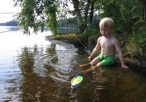 Tuomas playing with his sailboat (which has lost its mast)