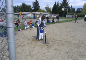Coach Kati helping Tuomas get into position to hit during the first game of the season