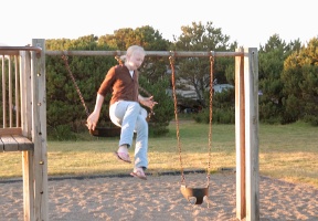 Johanna jumping off the swing