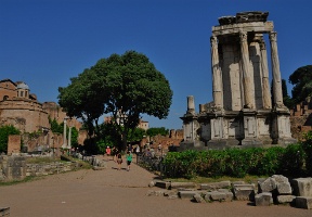 Walking on Vicus Vestae towards the Atrium Vestae. The Temple of Vesta is in the foreground.