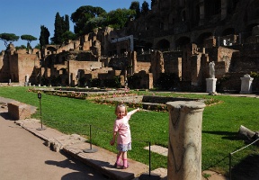 Elsa pointing at what used to be fountains in the Atrium Vestae.