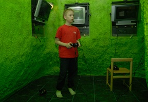 Tuomas playing on an XBox in the kids play area