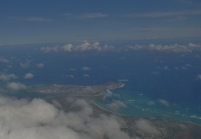 Approaching Honolulu - Waikiki Beach and Diamond Head visible beneath the clouds