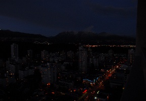 Night-time view of north Vancouver: Densmore Street is in the foreground with Lions Gate Bridge visible in the background.